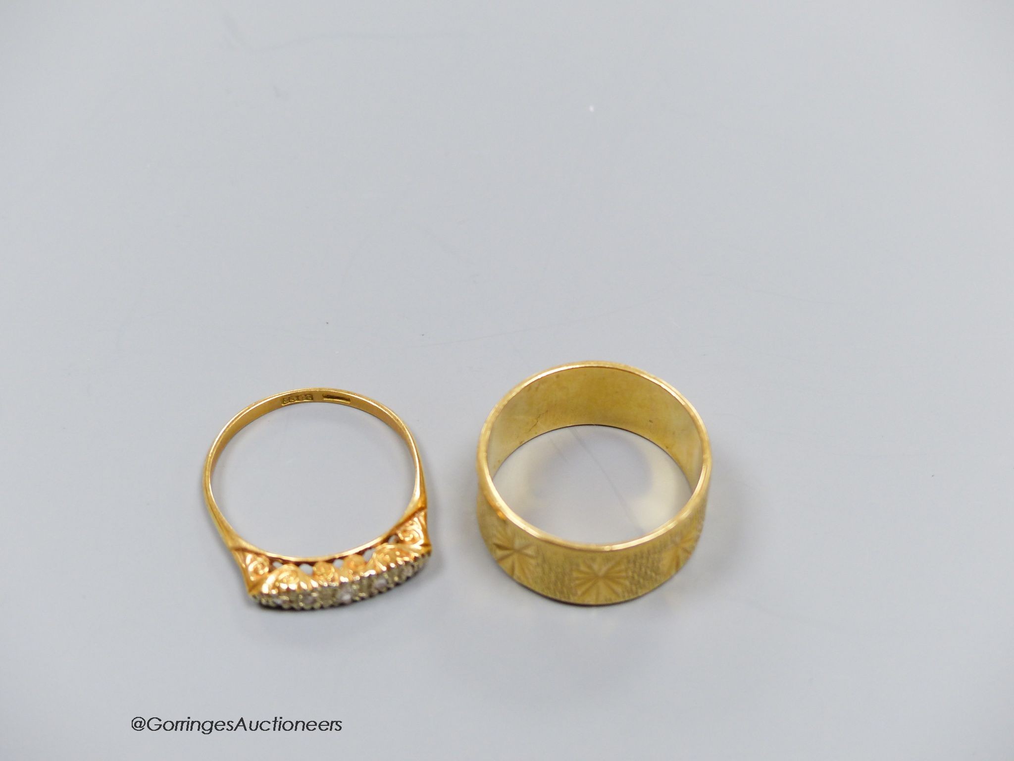An 18ct engraved gold ring, size Q, 7.1g, and another 18ct gold and diamond ring with scroll-carved mount, size Q, gross 2.8g. 9.9g